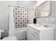 Stylish bathroom featuring patterned tile, a white vanity, and a shower-tub combination at 501 S Race St, Denver, CO 80209