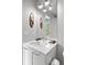 Bright and airy bathroom with a modern vanity, unique mirror and a window view at 501 S Race St, Denver, CO 80209