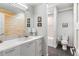 Contemporary bathroom with wood paneling, a large vanity, and a separate toilet area at 501 S Race St, Denver, CO 80209