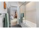 Modern bathroom design with a glass-enclosed tub and neutral tilework at 501 S Race St, Denver, CO 80209