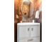 Stylish powder room features a modern vanity, round mirror and textured wall covering at 501 S Race St, Denver, CO 80209