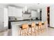 Spacious kitchen features a marble island with seating, modern appliances and custom cabinetry at 501 S Race St, Denver, CO 80209