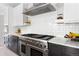 Well-equipped kitchen with stainless steel appliances, gas range, and subway tile backsplash at 501 S Race St, Denver, CO 80209