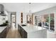 Modern kitchen with marble island, black cabinetry, and stainless steel appliances at 501 S Race St, Denver, CO 80209