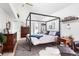 Spacious main bedroom featuring wood floors and a stylish four-poster bed frame at 501 S Race St, Denver, CO 80209