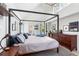 Bright main bedroom with a vaulted ceiling, canopy bed, and wood floors at 501 S Race St, Denver, CO 80209