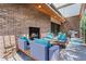 Relaxing outdoor seating area with fireplace, stylish furniture, and view of the backyard at 501 S Race St, Denver, CO 80209