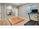 Basement fitness room with a treadmill, a mirrored wall, laminate flooring, and a large window at 17806 Coral Burst St, Parker, CO 80134