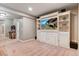 Basement Gathering room with built-in shelving, a large TV, arcade game and neutral carpet flooring at 17806 Coral Burst St, Parker, CO 80134