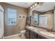 Bathroom featuring double sinks with a granite countertop, dark wood cabinetry, and a shower with a white curtain at 17806 Coral Burst St, Parker, CO 80134