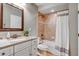 Bathroom vanity featuring a white countertop, white cabinetry, a mirror, and a shower with a white curtain at 17806 Coral Burst St, Parker, CO 80134