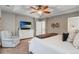 Bright bedroom with tray ceilings, comfortable furniture, and a large television at 17806 Coral Burst St, Parker, CO 80134