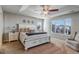 Serene bedroom with tray ceiling, natural light, a comfortable queen-sized bed and accent chair at 17806 Coral Burst St, Parker, CO 80134