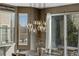 Elegant pendant lights hang above a dining room table near a window and sliding glass door at 17806 Coral Burst St, Parker, CO 80134