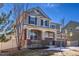Charming home with a cozy front porch, complemented by manicured landscaping and mature trees at 17806 Coral Burst St, Parker, CO 80134
