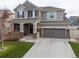 Lovely two-story home with a well-kept lawn, two-car garage, and inviting front porch at 17806 Coral Burst St, Parker, CO 80134
