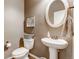 Stylish half bathroom featuring a pedestal sink, oval mirror, and decorative accents at 17806 Coral Burst St, Parker, CO 80134