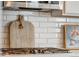 Close-up of a kitchen backsplash with a wooden cutting board hanging near stainless steel cooktop at 17806 Coral Burst St, Parker, CO 80134