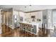 Open kitchen featuring white cabinetry, stainless steel appliances, and hardwood floors at 17806 Coral Burst St, Parker, CO 80134