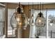 Stylish pendant lights illuminate the dining area, creating a warm and inviting ambiance at 17806 Coral Burst St, Parker, CO 80134