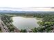 Scenic aerial view of a peaceful lake with walking trails and the surrounding neighborhood, ideal for outdoor enthusiasts at 7912 Fenton St, Arvada, CO 80003