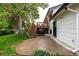 This backyard features a patio, wood deck stairs, and plenty of yard space for recreation and relaxation at 7912 Fenton St, Arvada, CO 80003