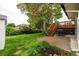 Backyard features a cement patio, wood deck stairs, and lush green landscaping at 7912 Fenton St, Arvada, CO 80003
