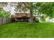 Expansive backyard featuring a large wood deck and lush green lawn, perfect for outdoor entertaining at 7912 Fenton St, Arvada, CO 80003