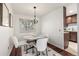 Cozy dining area featuring a chandelier, hardwood floors and four stylish chairs around table at 7912 Fenton St, Arvada, CO 80003
