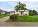 Inviting home with lush front lawn, mature trees, and attached garage with long driveway at 7912 Fenton St, Arvada, CO 80003