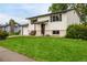 Classic home featuring a lush green lawn, attached garage, and welcoming front entrance at 7912 Fenton St, Arvada, CO 80003