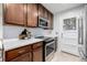 Modern kitchen featuring granite countertops, stainless steel appliances, and stylish backsplash at 7912 Fenton St, Arvada, CO 80003