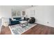Inviting living room with hardwood floors, a modern sofa, and a bright, airy atmosphere at 7912 Fenton St, Arvada, CO 80003