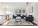Bright living room with hardwood floors, modern furniture, and ample natural light at 7912 Fenton St, Arvada, CO 80003