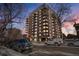 Stunning exterior view of a high-rise building with balconies, complemented by surrounding trees and street at 1150 Vine St # 201, Denver, CO 80206