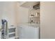 Convenient laundry area featuring a washer, dryer, and storage shelving at 1150 Vine St # 201, Denver, CO 80206