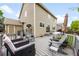 View of the home's cozy back deck featuring comfortable seating and an outdoor dining area, perfect for relaxing and entertaining at 2753 E 139Th Dr, Thornton, CO 80602