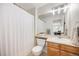 Well-lit bathroom with tile flooring, modern fixtures, a large mirror, and shower-tub combination at 2753 E 139Th Dr, Thornton, CO 80602