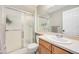 Bright bathroom featuring a shower with sliding glass doors, vanity with sink, and neutral color scheme at 2753 E 139Th Dr, Thornton, CO 80602