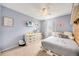 Comfortable bedroom with blue paint, soft carpet, modern dresser, window for natural light, and neutral decor at 2753 E 139Th Dr, Thornton, CO 80602