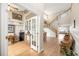 Bright foyer featuring hardwood floors, an open staircase, and views into the dining and living spaces at 2753 E 139Th Dr, Thornton, CO 80602