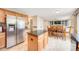 Open concept kitchen with stainless steel refrigerator, breakfast nook, and view of the Gathering room at 2753 E 139Th Dr, Thornton, CO 80602