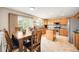 Bright eat-in kitchen features an island, stainless appliances, granite countertops and wooden cabinetry at 2753 E 139Th Dr, Thornton, CO 80602