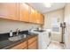Laundry room features cabinetry, granite countertops and stainless steel sink at 2753 E 139Th Dr, Thornton, CO 80602