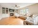 Inviting living room featuring a fireplace, custom built-ins, and a comfortable sectional couch at 2753 E 139Th Dr, Thornton, CO 80602