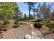 Backyard landscaping includes a stone path, a seating area, and an in-ground trampoline at 5414 Golden Currant Way, Parker, CO 80134