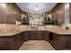 Finished basement with custom cabinetry, a bar, and stylish backsplash at 5414 Golden Currant Way, Parker, CO 80134