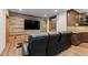 Finished basement with a wood wall, tv, and custom bar area at 5414 Golden Currant Way, Parker, CO 80134