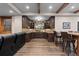 Finished basement with a bar, custom cabinets, and a leather sofa set at 5414 Golden Currant Way, Parker, CO 80134
