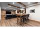 Finished basement with a wooden bar, leather seating, and a rustic wood wall at 5414 Golden Currant Way, Parker, CO 80134